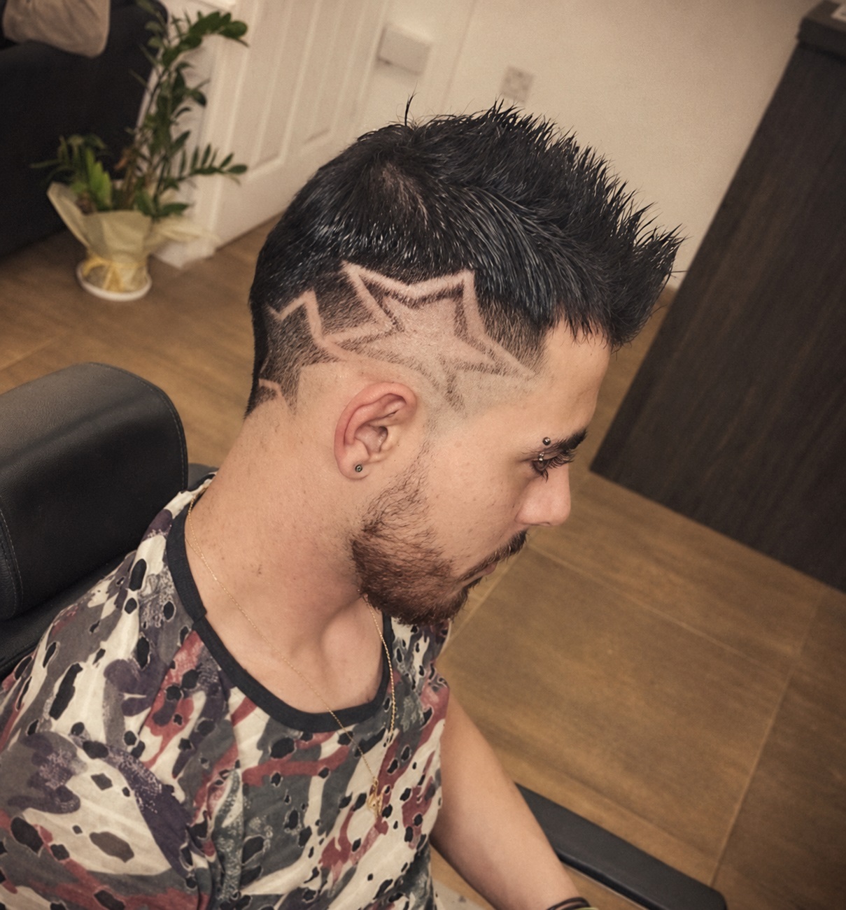 Man with two overlapping stars shaved into the side of his fade